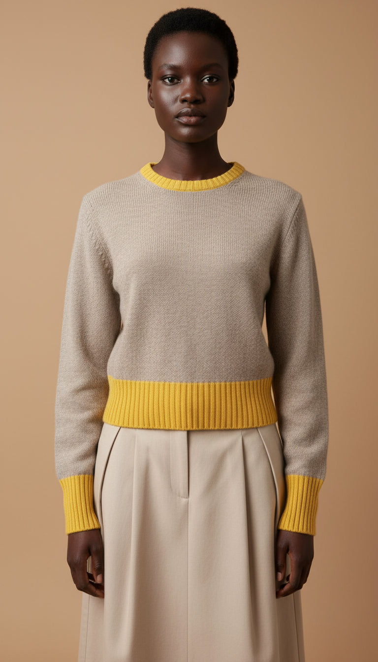 Person wearing a gray sweater with yellow accents 