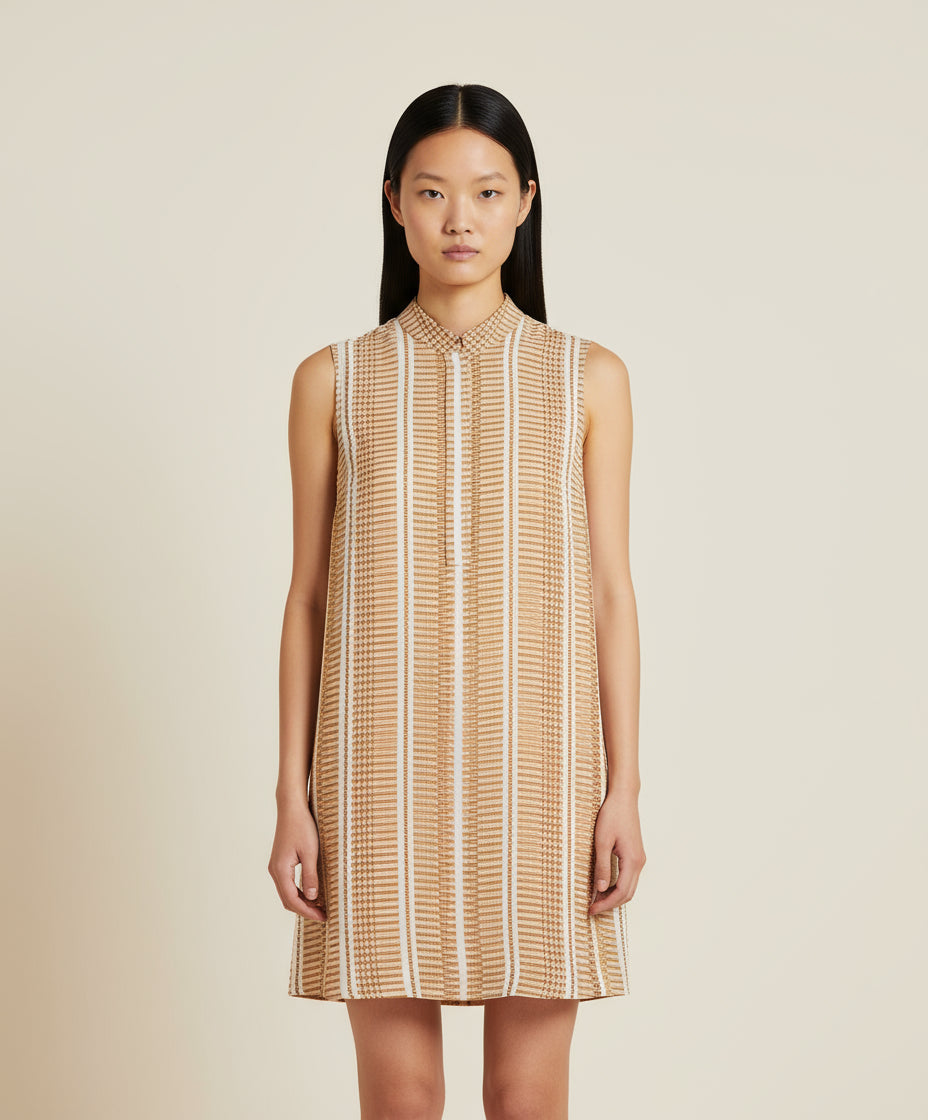 A sleeveless, striped ivory and beige mini dress with a round neckline and no visible sleeves.