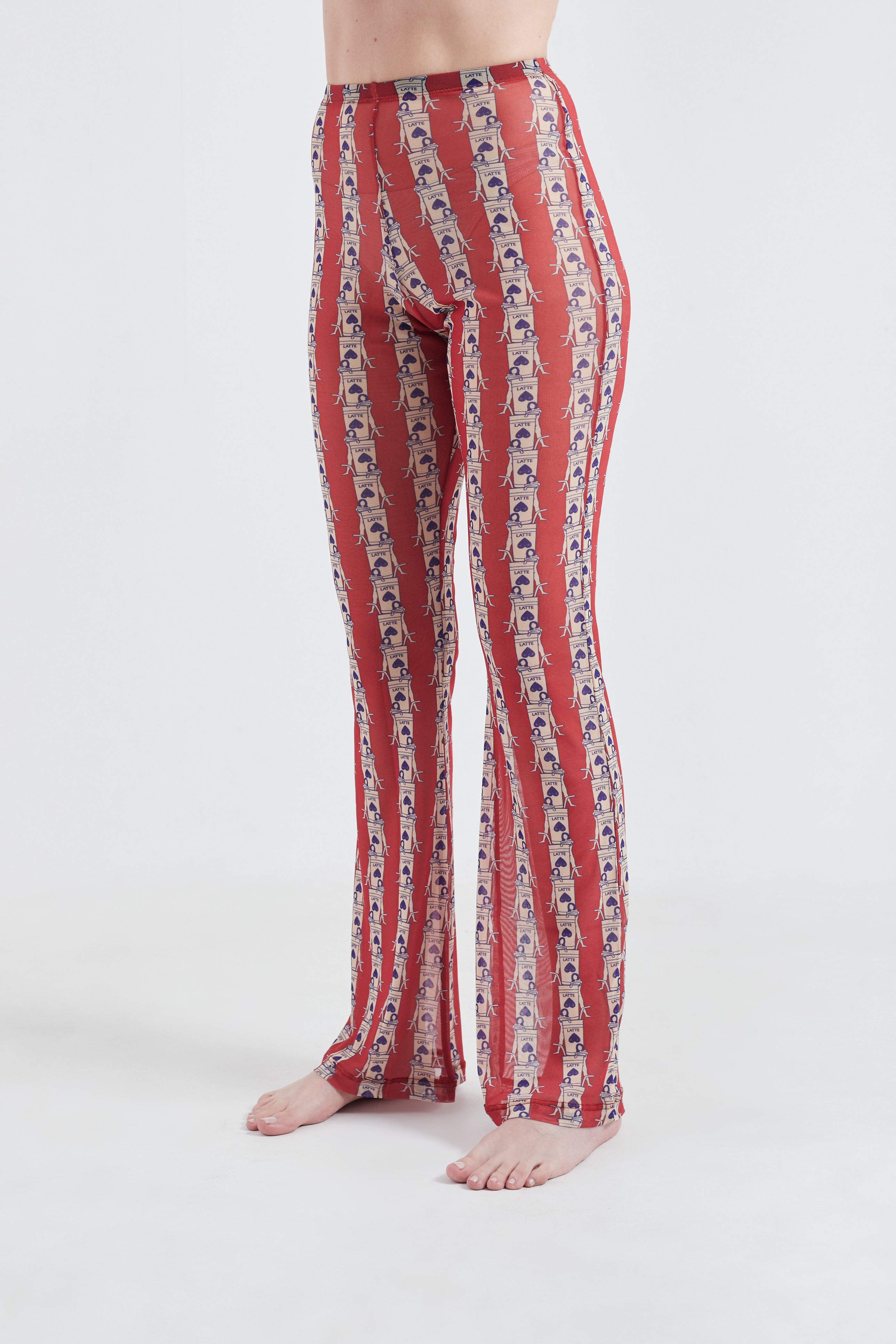 Red patterned pants worn by a person on a white background