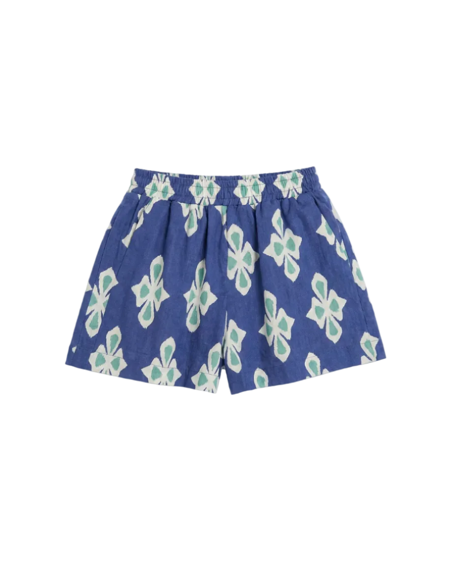 Blue shorts with white and green floral pattern on a white background