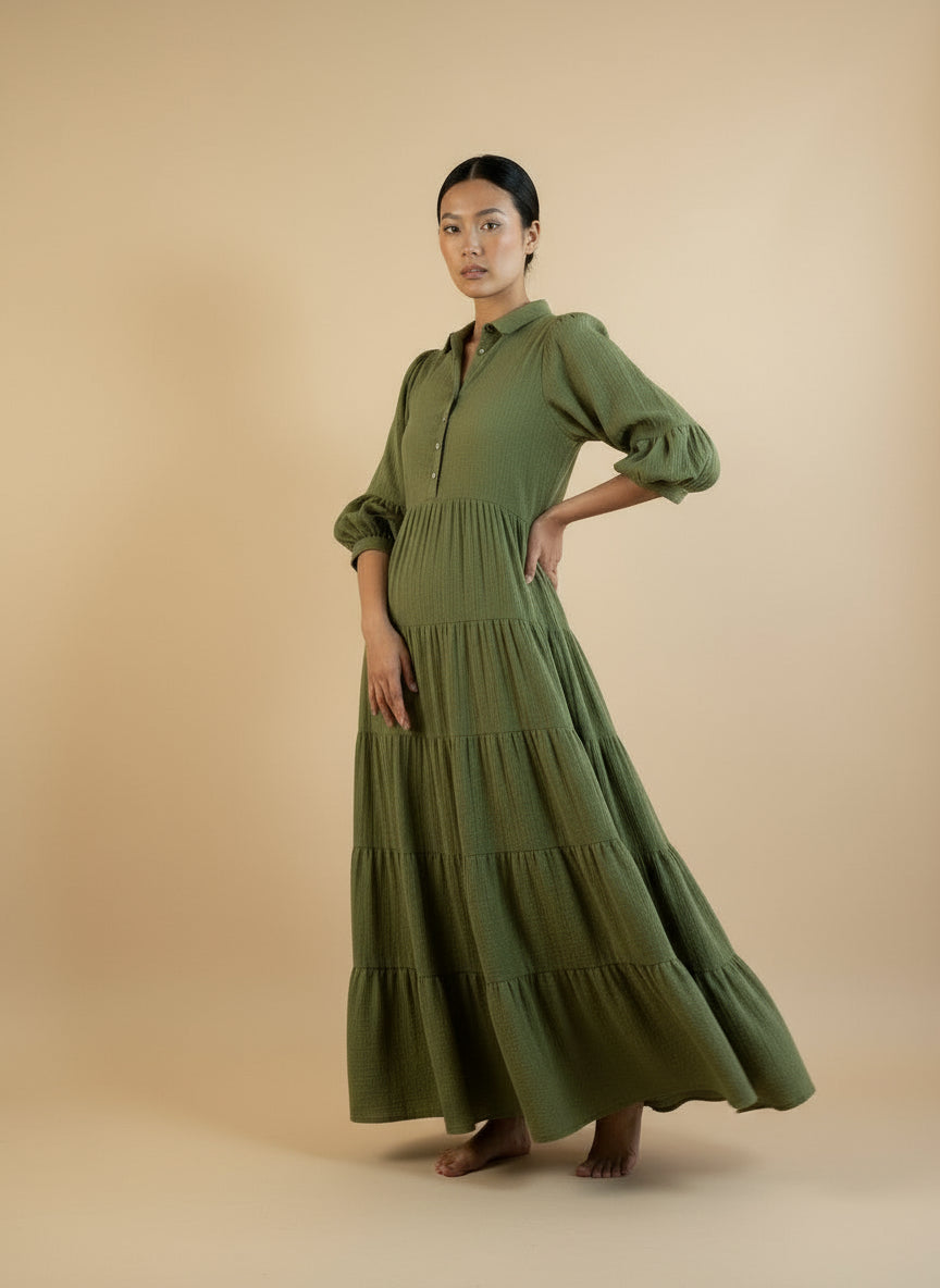 Woman wearing a green dress against a beige background